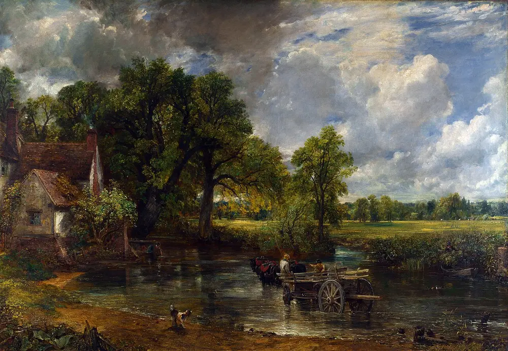 A horse-drawn farm wagon stands in a shallow river beside a cottage, with a dog on the bank, tall dark trees and sunny meadows beyond under a sky of big white clouds.