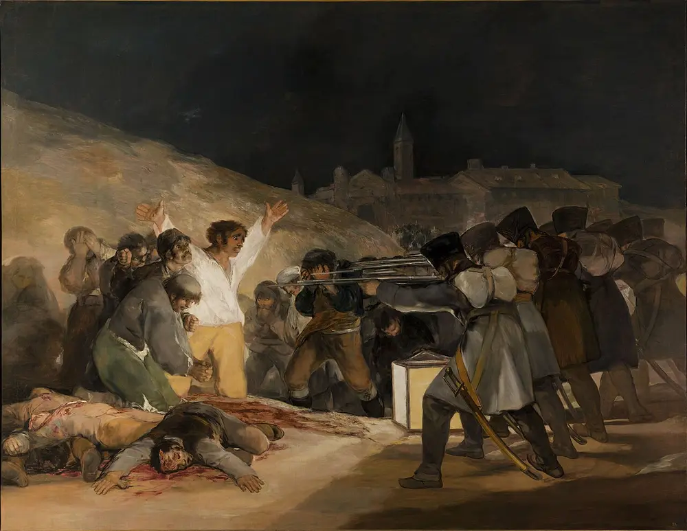 At night, a row of soldiers with rifles aims at a group of Spanish men; one man in a white shirt flings his arms up in the light of a big lantern, with dead bodies on the ground in front of him.