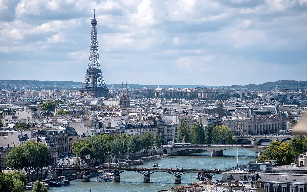 The rooftops of Paris and the river Seine with its bridges, with the Eiffel Tower in the distance.