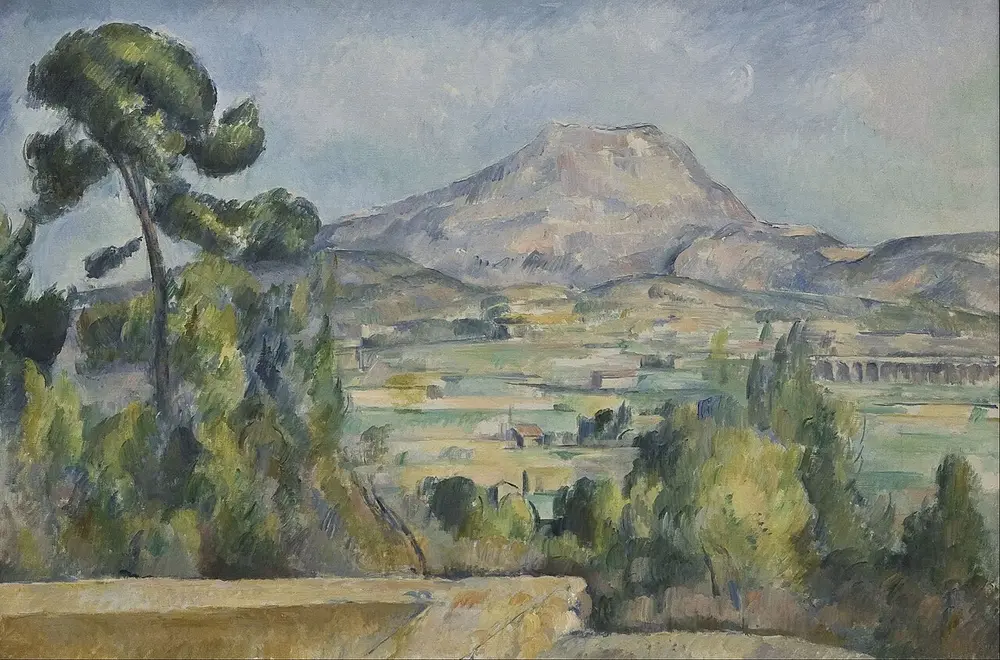 A broad Provence landscape of fields, houses and trees in greens and ochres, with a tall pine on the left, a viaduct on the right and a pale grey-pink mountain in the distance.
