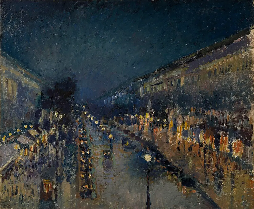 A wide Paris boulevard at night seen from above, wet with rain, lit by rows of yellow shop windows and white street lamps under a dark blue sky.