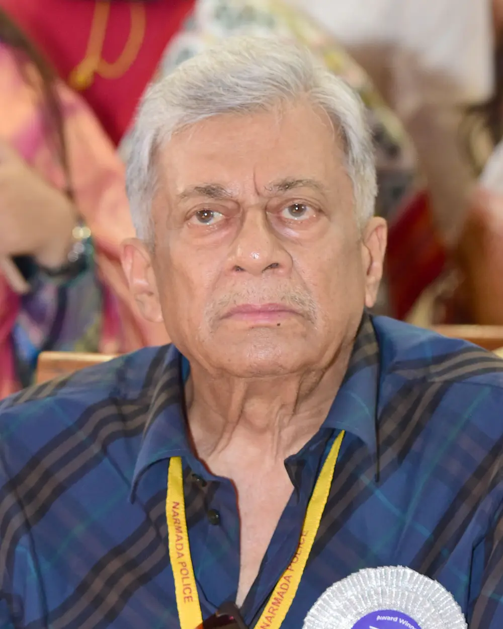 The actor Anant Nag, an older man with white hair, in a checked shirt and a lanyard, at the National Film Awards ceremony in 2026.