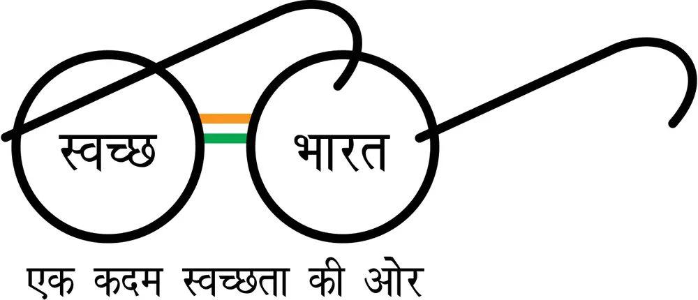 A line drawing of round spectacles with Swachh in one lens and Bharat in the other in Devanagari, a small saffron and green bridge between them, and a Hindi slogan written below.