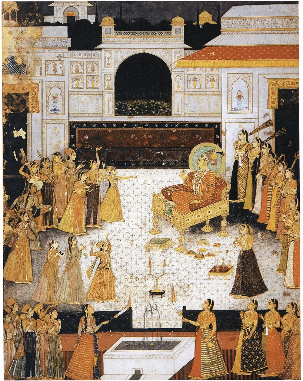 A Jodhpur ruler sits on a terrace in a white palace courtyard, watching rows of women dance and play music around him.
