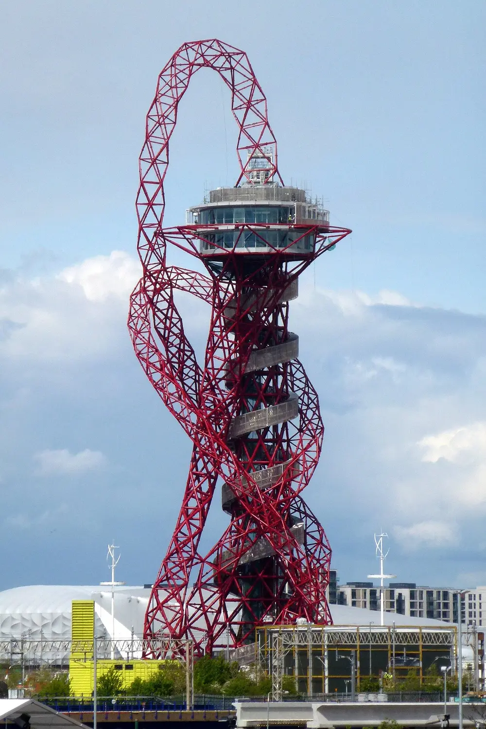 The ArcelorMittal Orbit in London, a tall red steel tower made of looping, twisting tubes with a round viewing deck near the top.