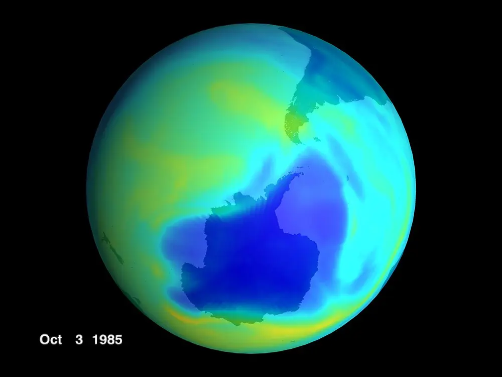 A satellite map of the Earth seen from below the South Pole, coloured to show ozone, with a large dark-blue patch of thin ozone over Antarctica, dated 3 October 1985.