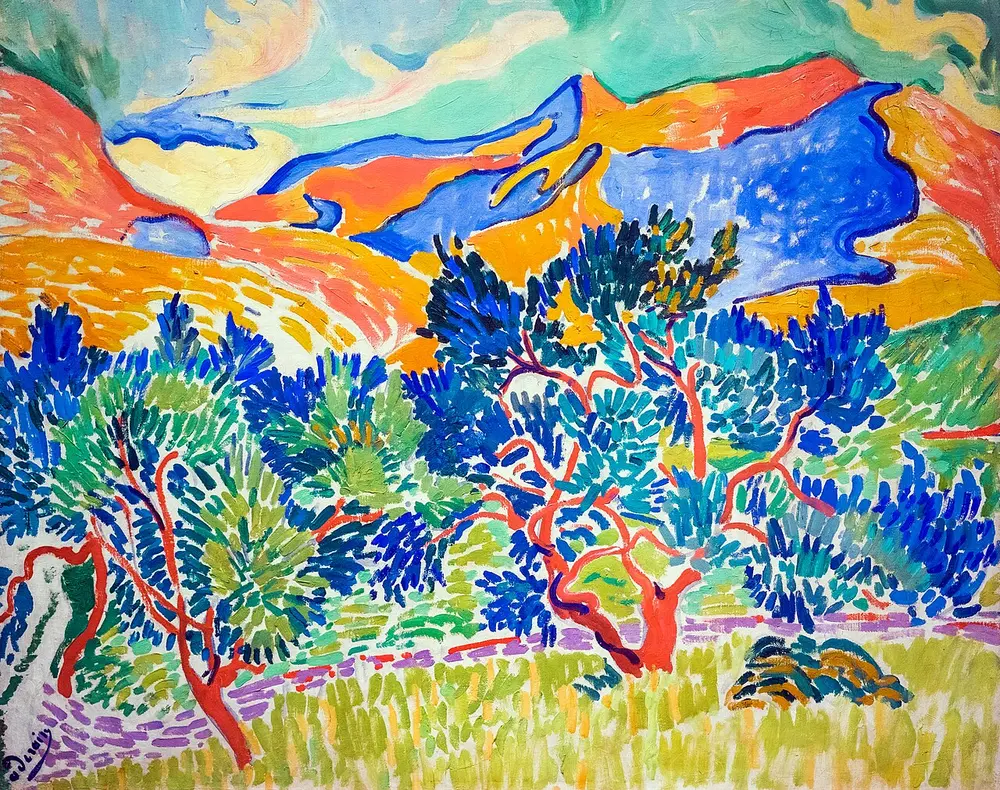 A landscape of trees with red trunks and blue and green leaves in front of orange, pink and blue mountains, painted in short strokes and flat patches of pure, bright colour.