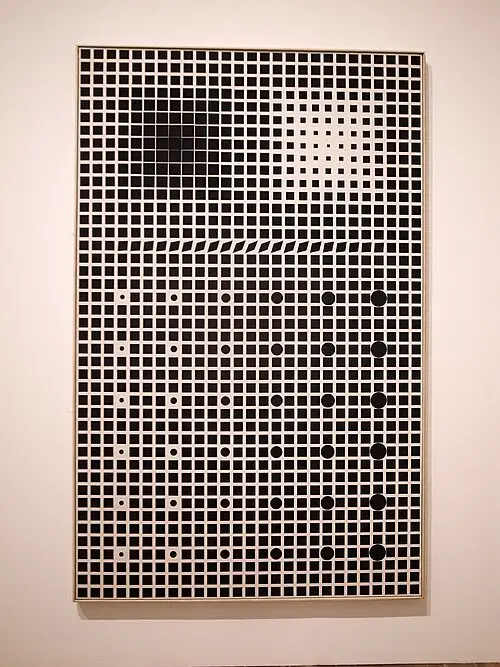 A tall black-and-white painting hanging on a gallery wall, made of a grid of small squares and circles that grow, shrink and fade in places, so that the grid seems to bulge and flicker.
