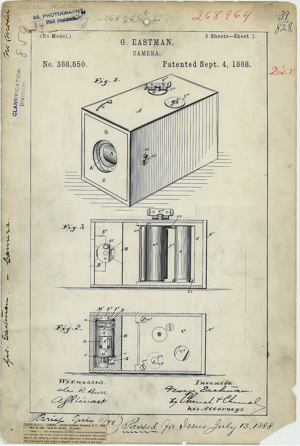 A yellowed patent drawing of a box camera, shown from the side and from above with its roll of film and winding parts inside.