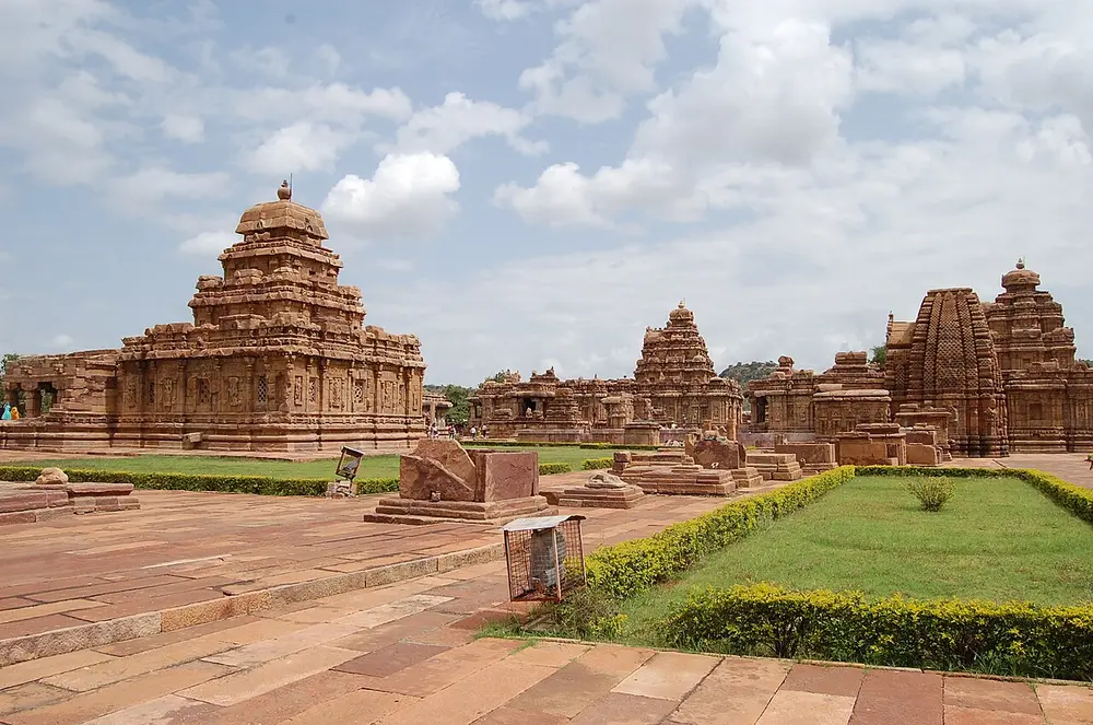 The temple group at Pattadakal: on the left a temple with a stepped pyramid tower, in the middle another stepped tower, and on the right a temple with a curved northern-style tower.