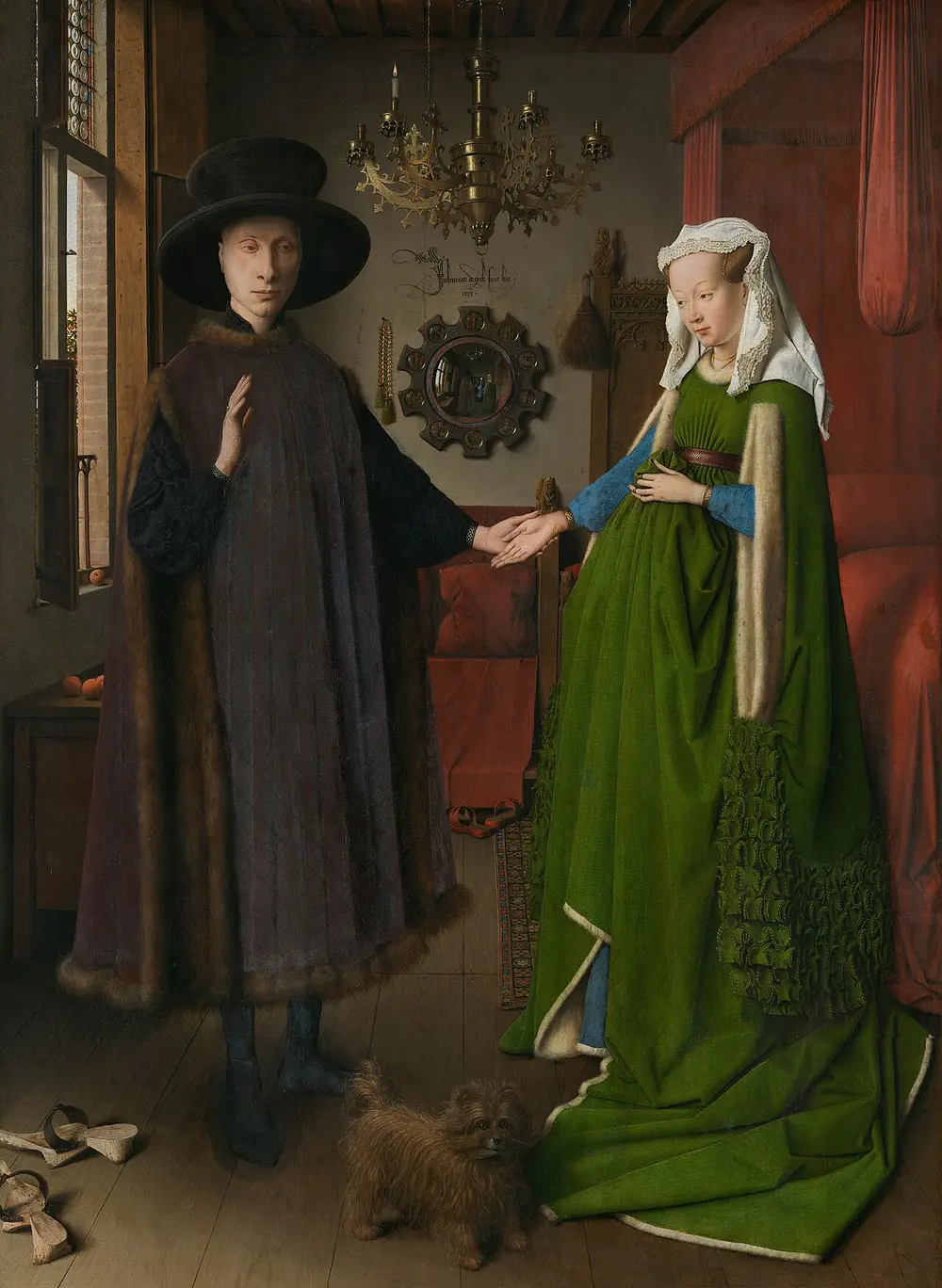 A man in a large black hat and fur-trimmed robe holds the hand of a woman in a green dress in a room with a brass chandelier, a round mirror on the back wall and a small dog at their feet.