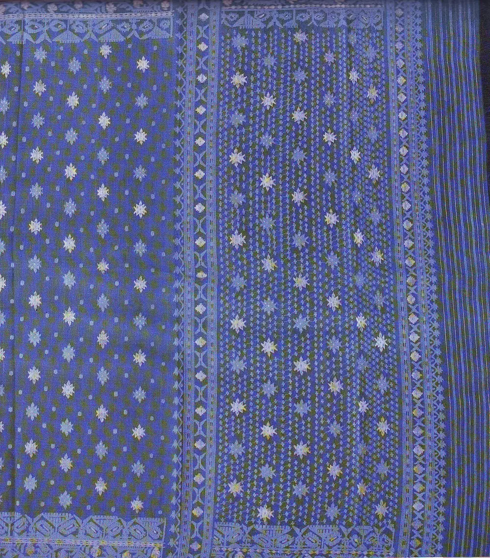 A blue cotton sari with rows of small white star-shaped flowers woven into the fabric and a patterned border.